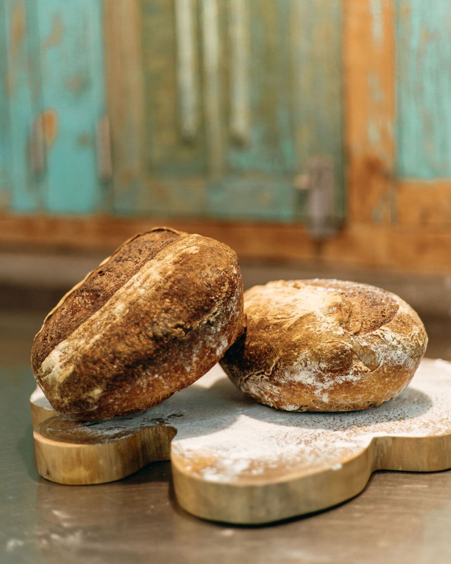 Two loaves of sourdough bread on a wooden board