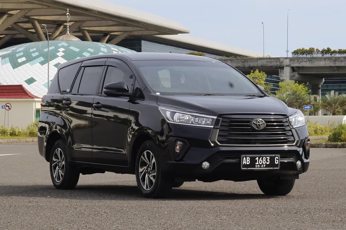 A black Toyota Innova people carrier outside an airport terminal in Indonesia