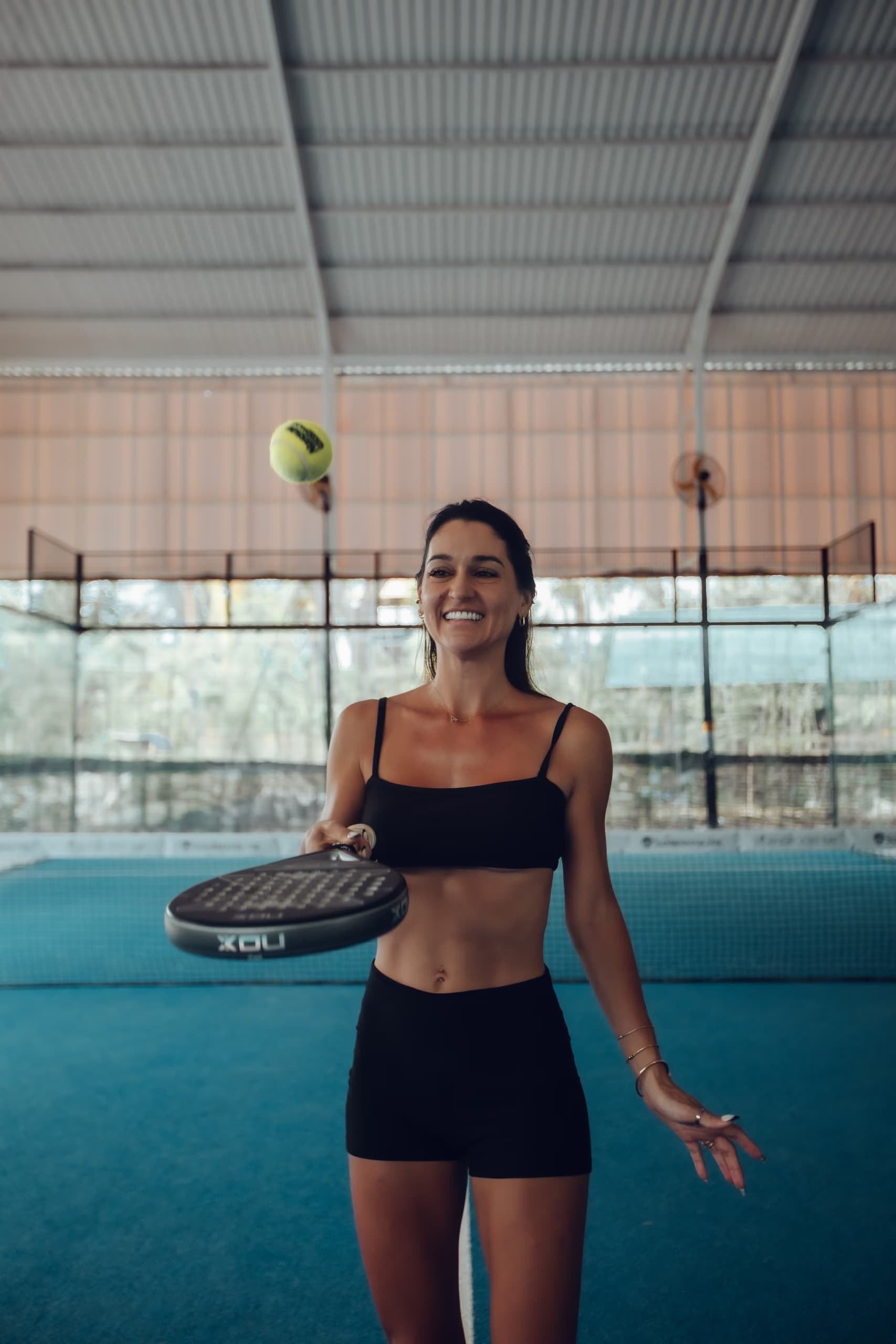 Padel player bouncing ball on racket