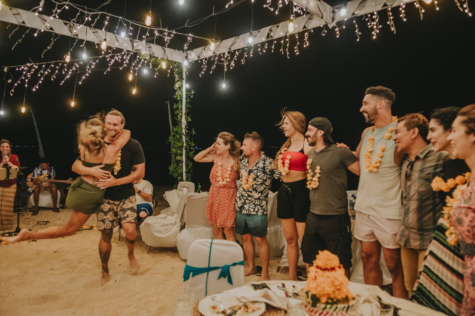 Joyful beach celebration with dancing at Gilih Putih