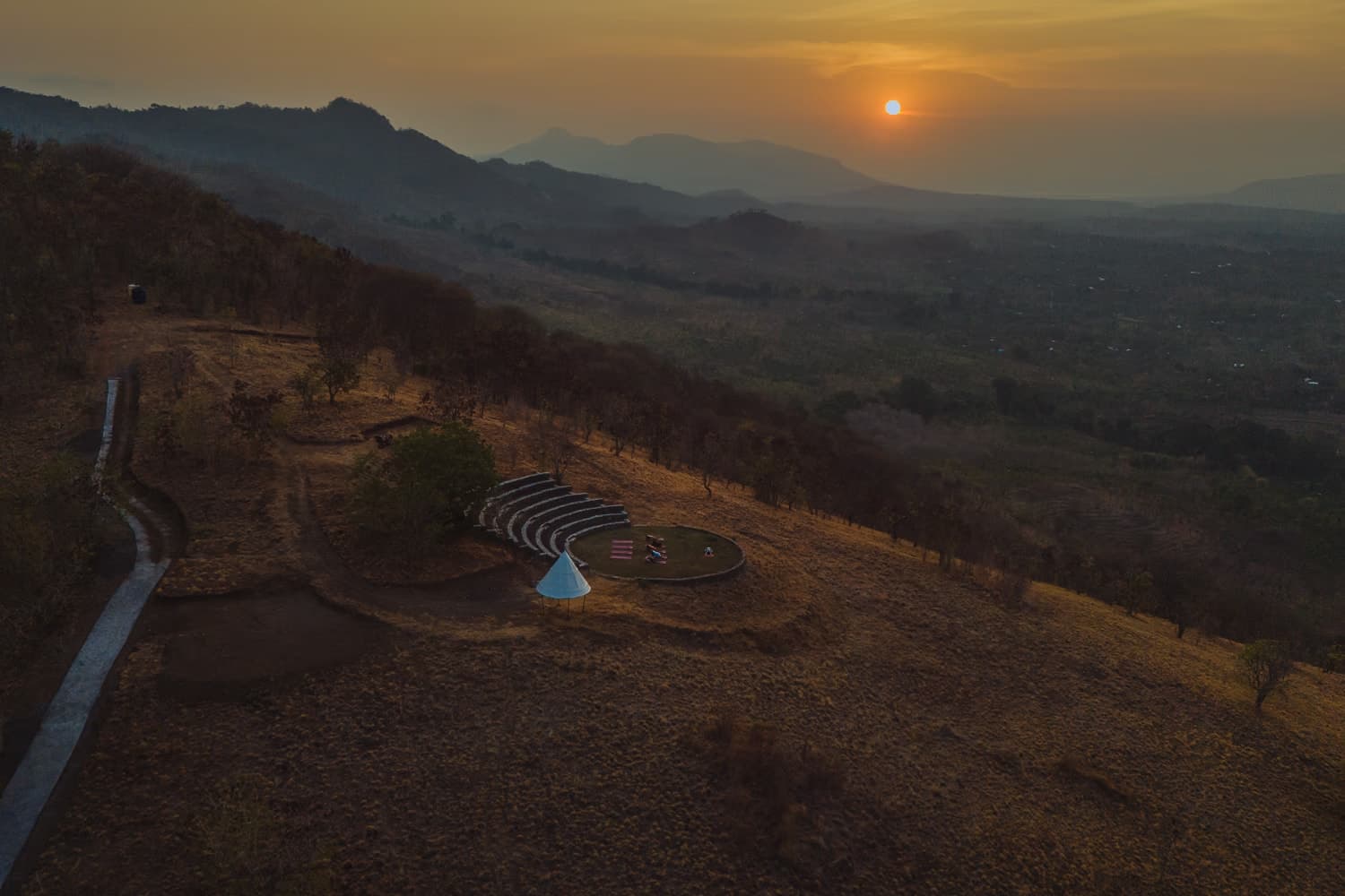 Sunset yoga at Sumberkima Stage with panoramic hill and volcano views