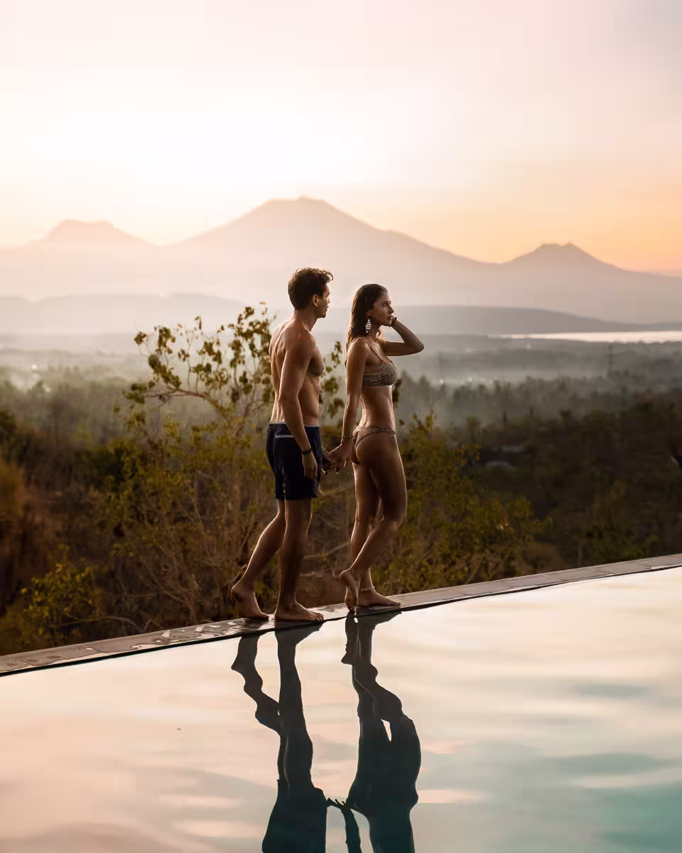 Couples enjoying relaxing poolside experience with natural surroundings