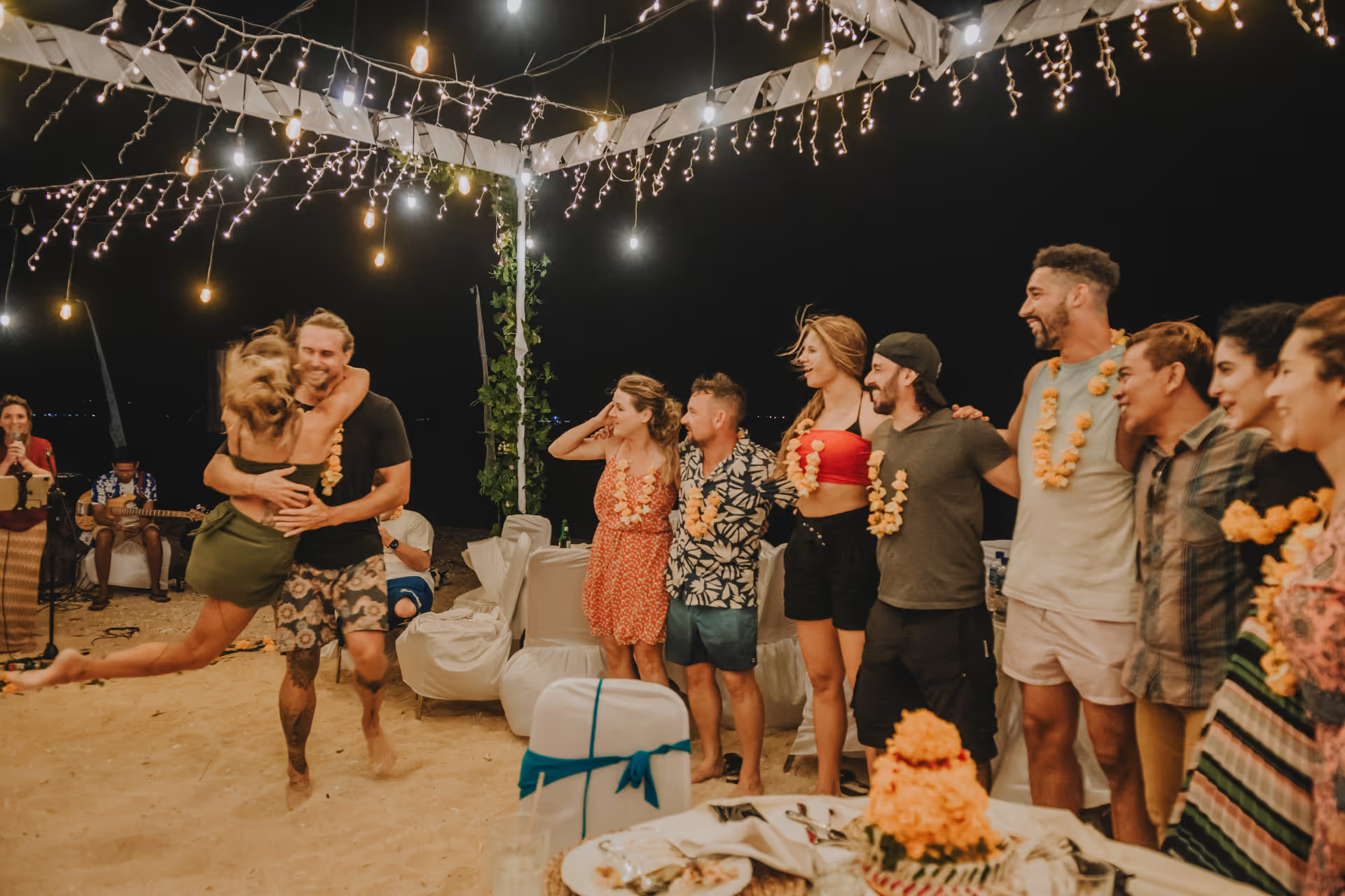 Joyful beach celebration with dancing at Gilih Putih