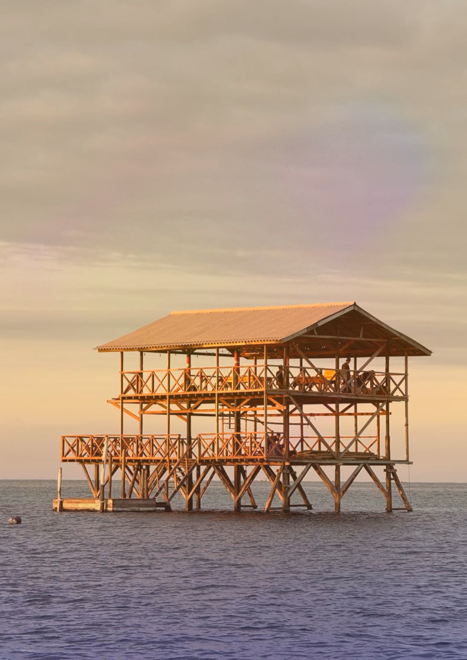 Metamorfosa Outpost at sunset in Sumberkima Bay
